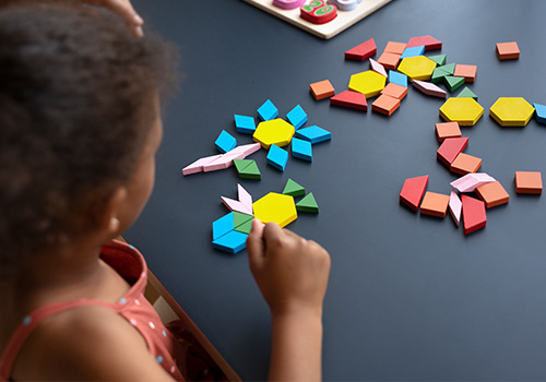 Playing with children with colored cards stuck to the wall