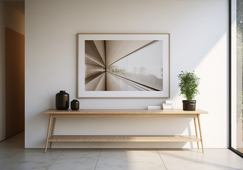 The wall of the room is decorated with mirrors and art frames and lighting